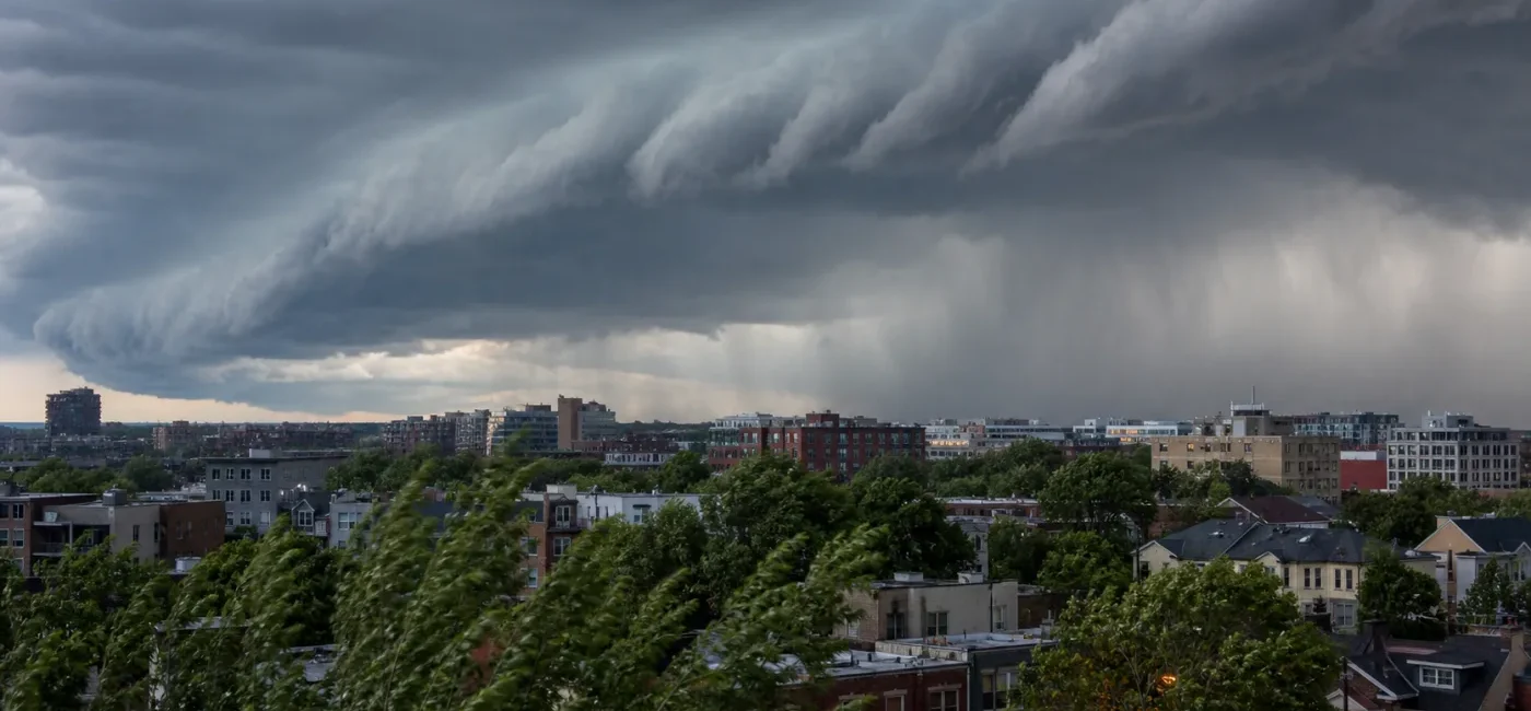 A severe thunderstorm shelf cloud and rain approaching an urban neighborhood in the Washington, D.C. region