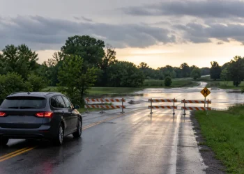 Vehicle safely turning away from barricades before a flooded Ohio road